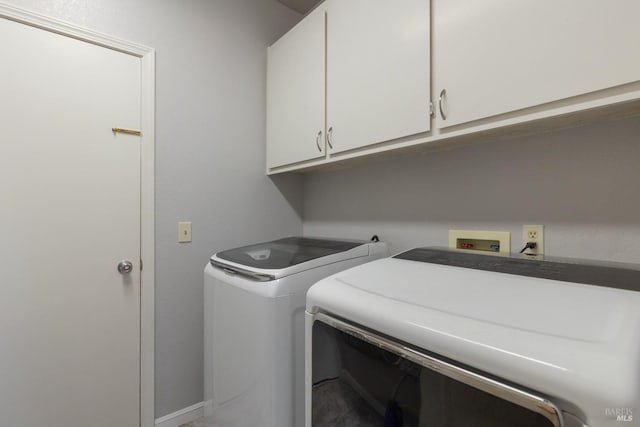 washroom with washer and dryer and cabinet space