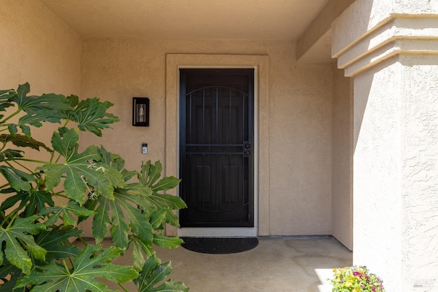 doorway to property with stucco siding