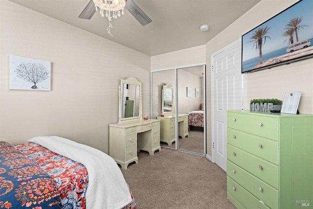 carpeted bedroom featuring a ceiling fan and a closet