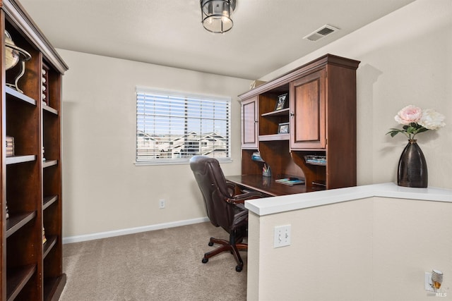 carpeted office space with baseboards and visible vents