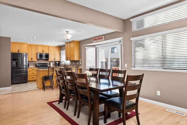 dining room with visible vents, recessed lighting, baseboards, and light wood-style floors