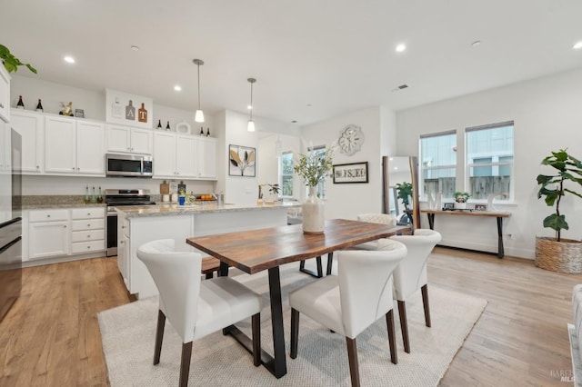 dining room with recessed lighting, visible vents, and light wood-style flooring