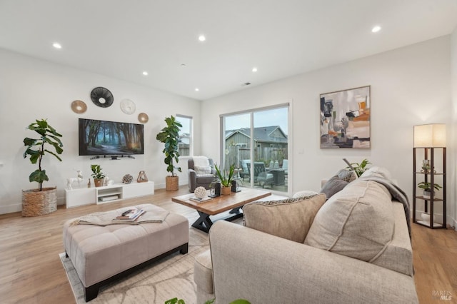 living area featuring recessed lighting, wood finished floors, and baseboards