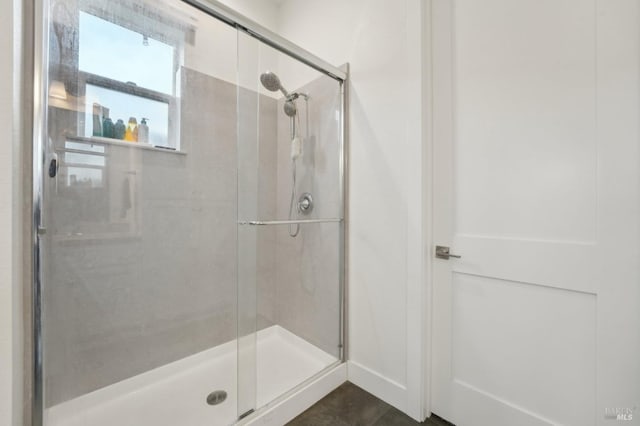 full bath with a shower stall