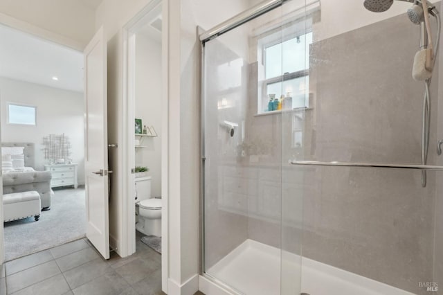 full bathroom featuring toilet, a stall shower, and tile patterned flooring