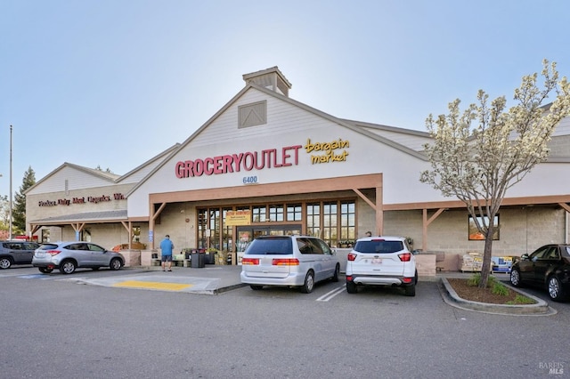 view of building exterior with uncovered parking