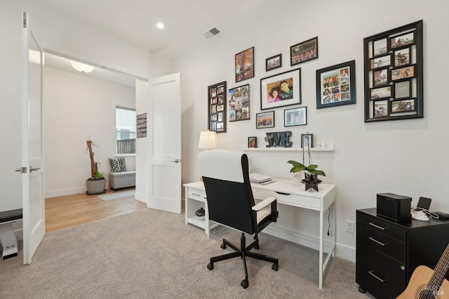 carpeted office space with recessed lighting, baseboards, and visible vents