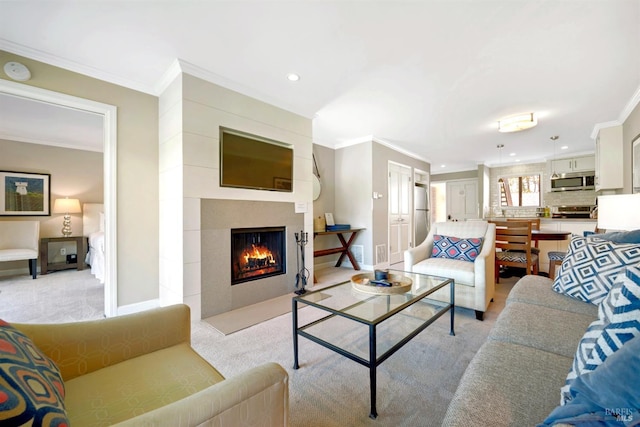 living room with baseboards, a fireplace with flush hearth, light colored carpet, and crown molding