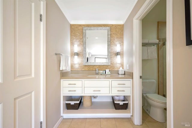 bathroom with vanity, toilet, tile patterned flooring, and ornamental molding