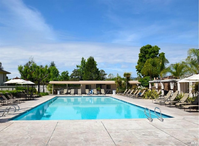 pool featuring a patio and fence