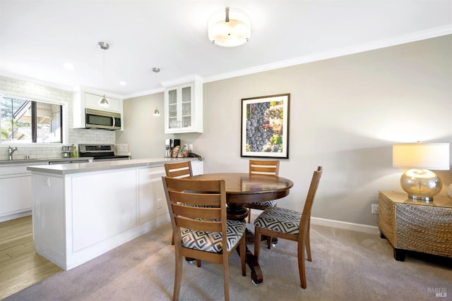 dining area featuring recessed lighting, light colored carpet, baseboards, and ornamental molding