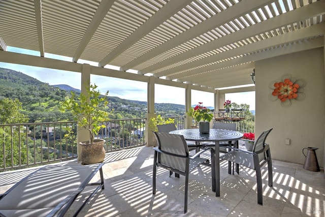 view of patio / terrace featuring a mountain view, a pergola, and outdoor dining area