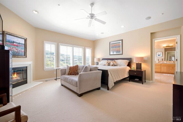 carpeted bedroom with a glass covered fireplace, recessed lighting, baseboards, and a ceiling fan