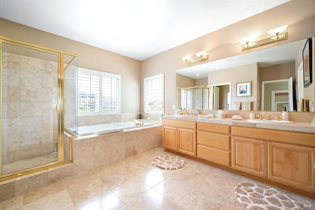 bathroom featuring a shower stall, a bath, double vanity, and a sink