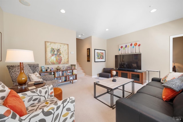 carpeted living area with recessed lighting and baseboards