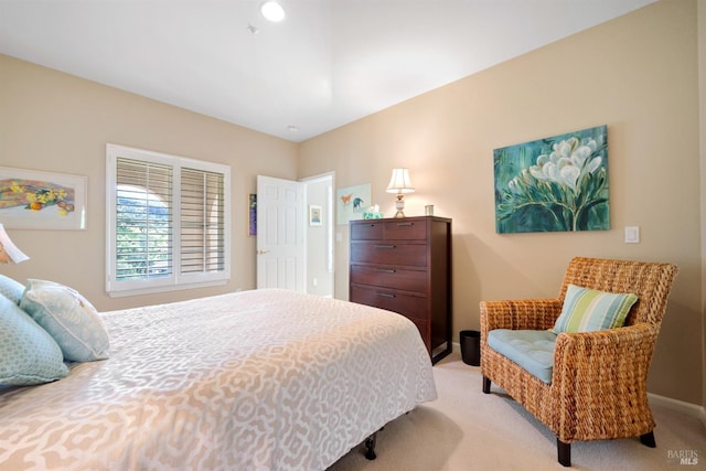 bedroom with baseboards and light carpet