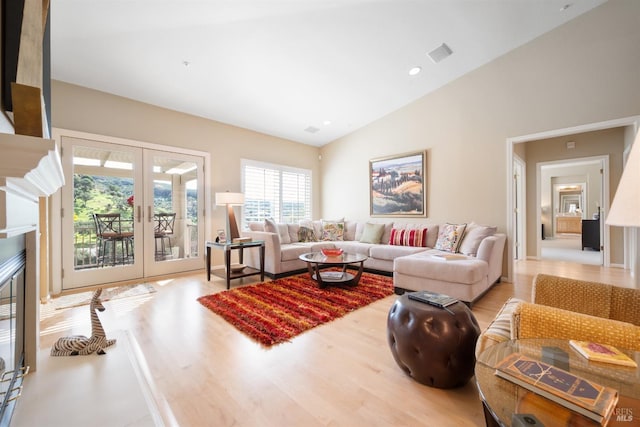 living area with vaulted ceiling, wood finished floors, french doors, and recessed lighting