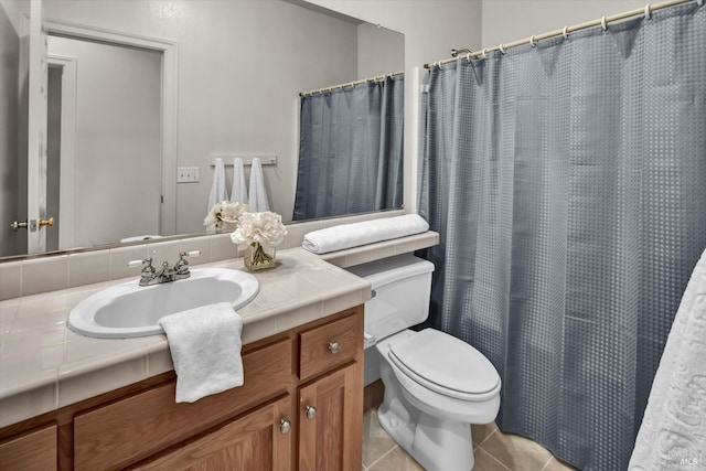 full bathroom with toilet, vanity, and tile patterned flooring