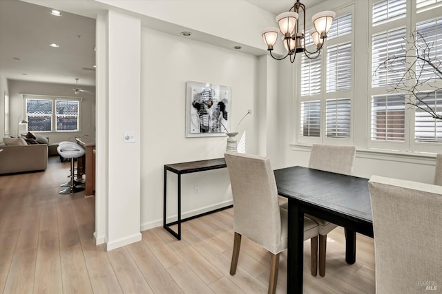 dining room featuring recessed lighting, light wood-style floors, baseboards, and a chandelier