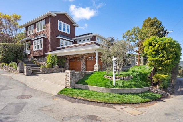 view of front of house featuring stairway, a garage, and driveway