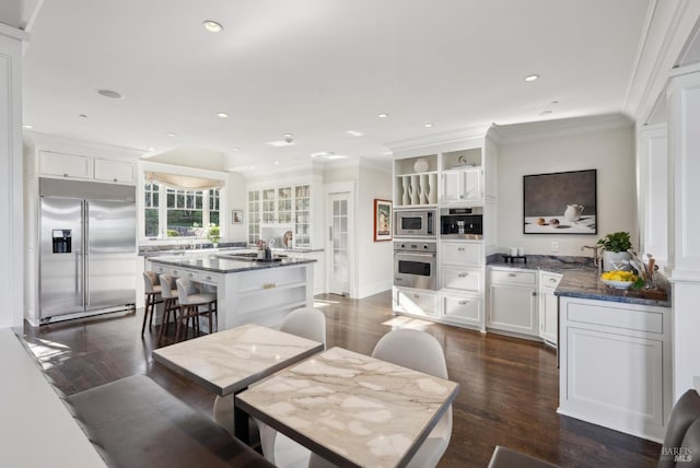 dining area with recessed lighting, dark wood-style floors, and ornamental molding