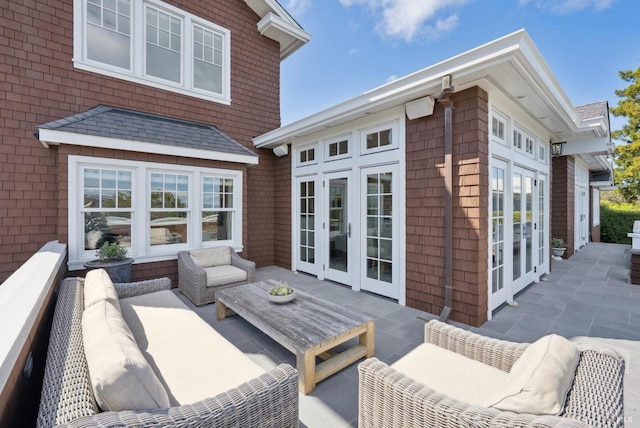 deck featuring an outdoor living space, french doors, and a patio