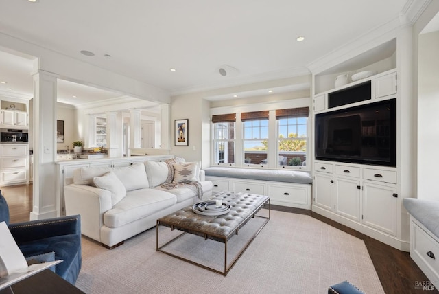 living room with recessed lighting, wood finished floors, and ornamental molding