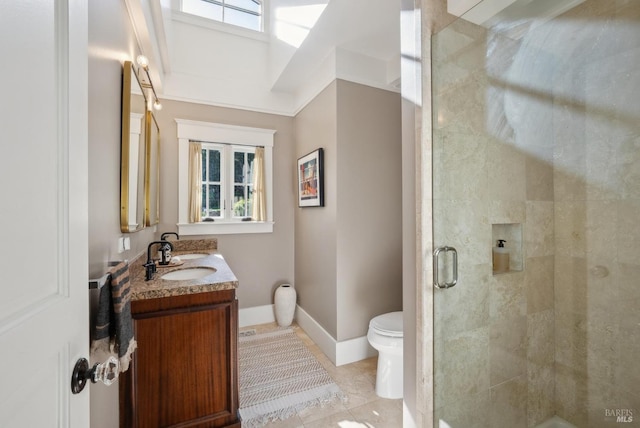 full bath featuring vanity, baseboards, a shower stall, tile patterned floors, and toilet