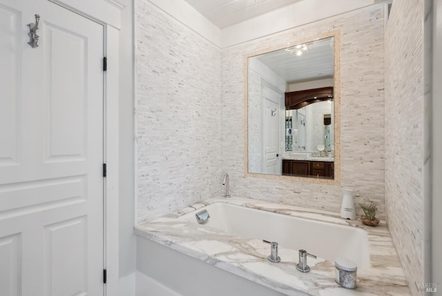 bathroom featuring vanity and a garden tub