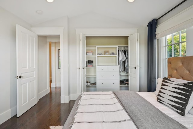 bedroom featuring dark wood-style floors, recessed lighting, a closet, baseboards, and vaulted ceiling