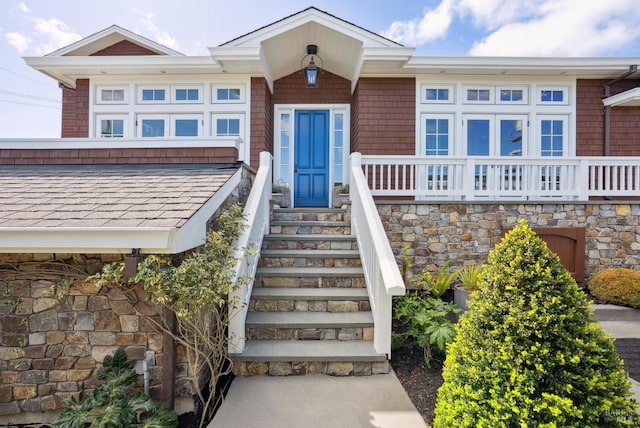 doorway to property featuring stone siding