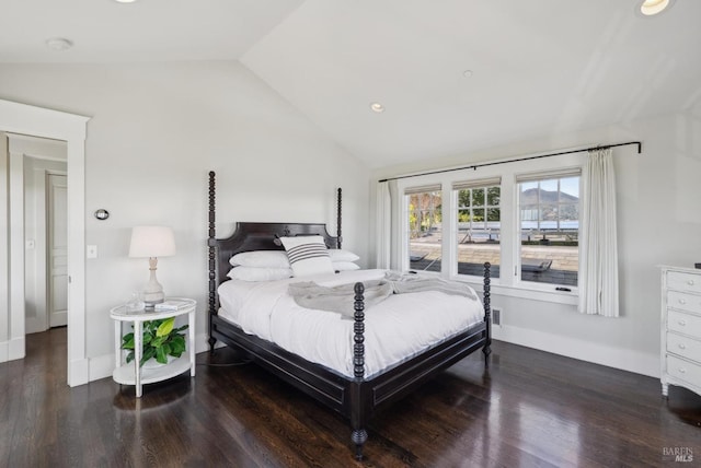 bedroom with baseboards, lofted ceiling, and wood finished floors