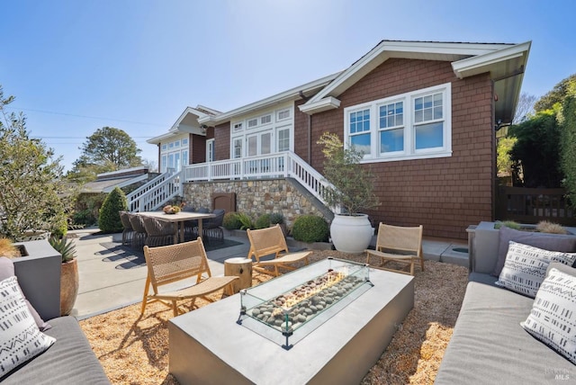 view of patio / terrace featuring stairs and a fire pit