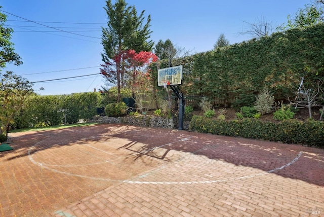 view of sport court with basketball hoop