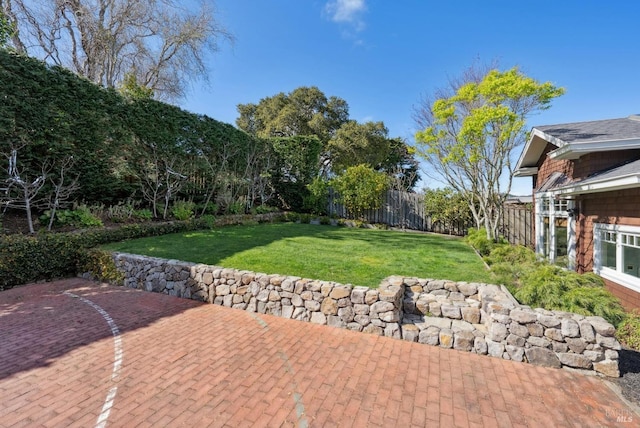 view of yard featuring a patio and fence