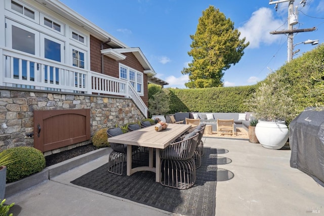 view of patio featuring an outdoor living space, outdoor dining area, and stairway