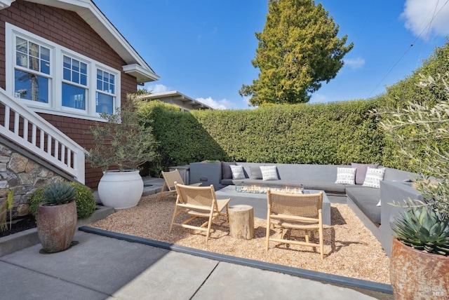 view of patio featuring an outdoor living space with a fire pit