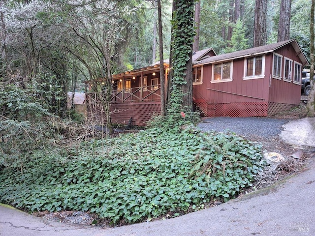 view of side of home with a view of trees