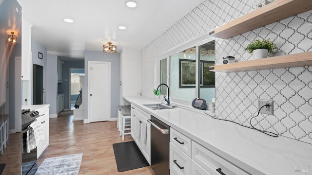 kitchen featuring open shelves, a sink, light countertops, white cabinets, and dishwasher