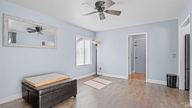 unfurnished room featuring ceiling fan, baseboards, and wood finished floors