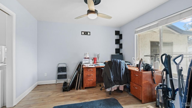 office featuring light wood-style flooring, baseboards, and ceiling fan