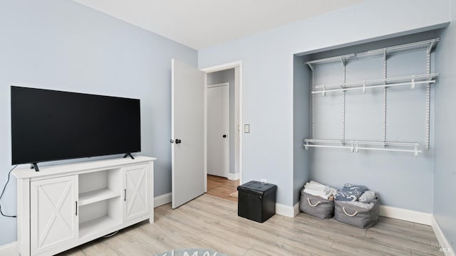 bedroom with light wood-style floors and baseboards