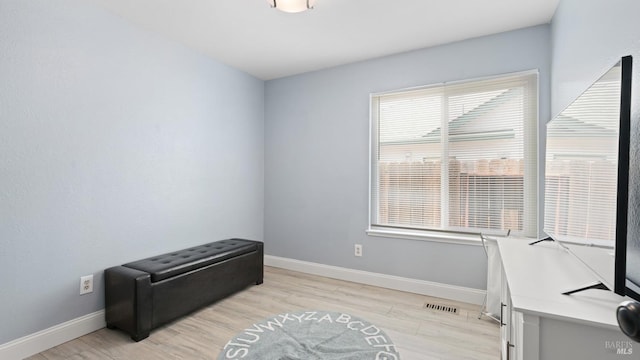 home office featuring baseboards, visible vents, and light wood-type flooring