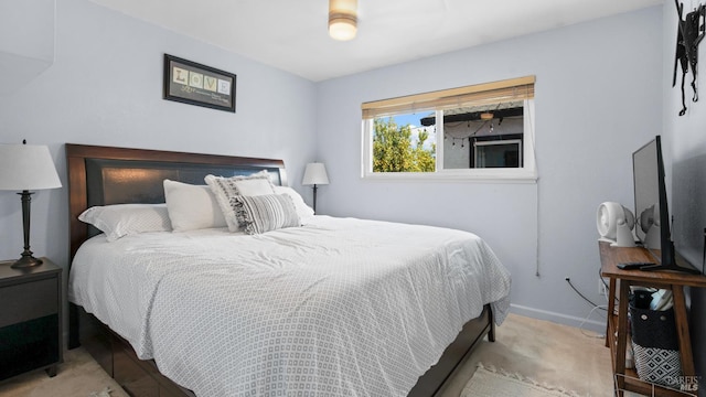 bedroom with baseboards and carpet floors