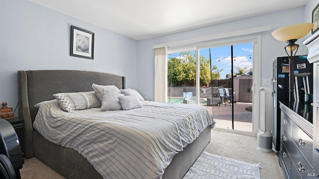 bedroom featuring access to exterior and light colored carpet