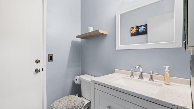 bathroom with toilet and vanity