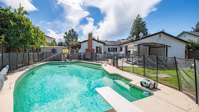 view of pool with a lawn, a fenced backyard, a diving board, a fenced in pool, and a patio area