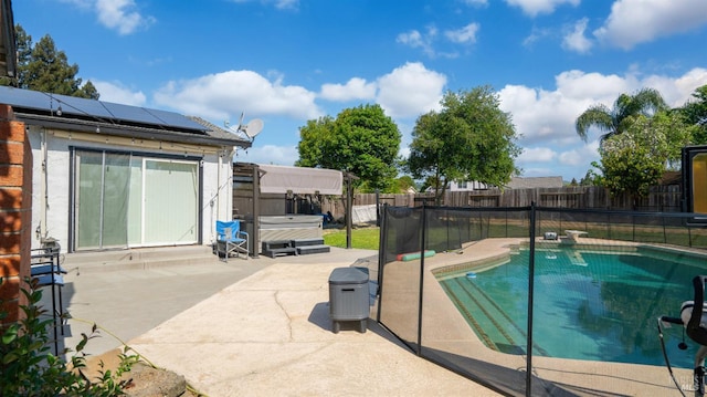 view of swimming pool with a patio area, a fenced in pool, a hot tub, and a fenced backyard