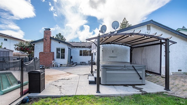 view of patio / terrace with a carport, fence, a pergola, and a hot tub