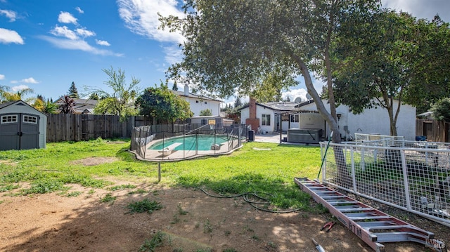 view of yard with a fenced in pool, a fenced backyard, an outdoor structure, a storage unit, and a jacuzzi